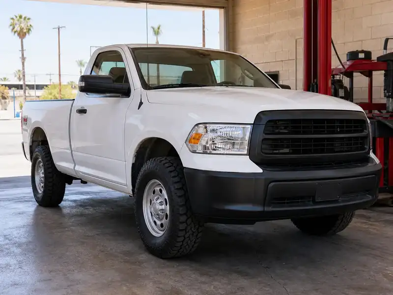 White pickup with new all-terrain tires
