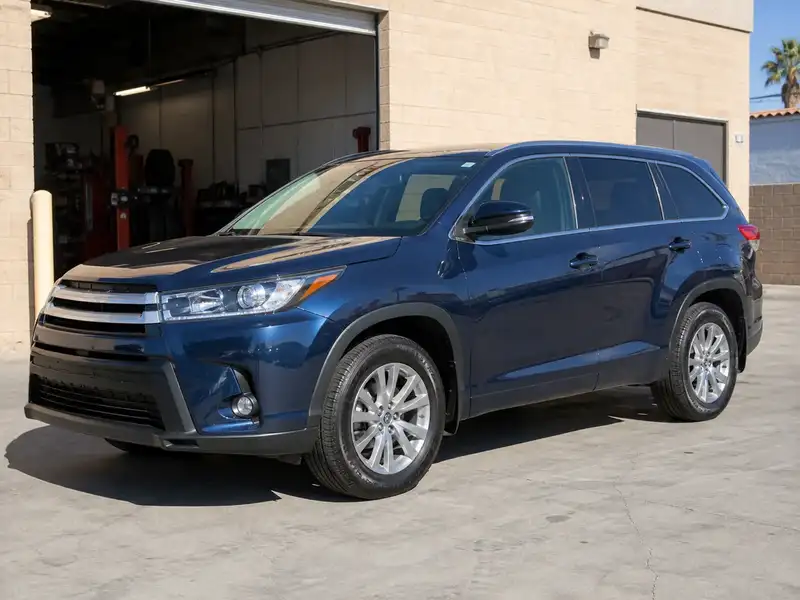 Blue family SUV with new tires outside the shop