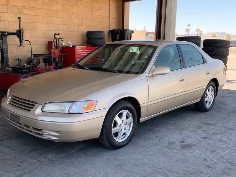 Gold sedan with freshly installed new tires