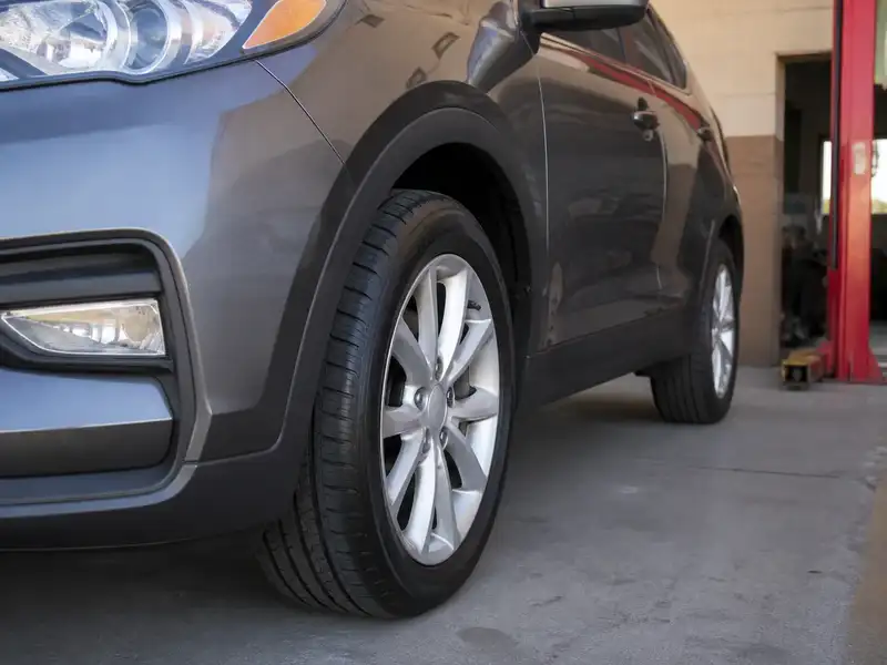 Close-up of a new tire and wheel on a gray crossover