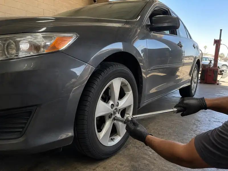 Technician applying final torque to a new wheel