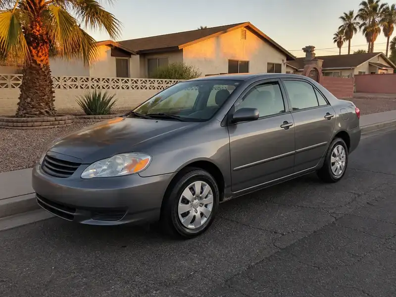 Gray sedan with new tires in golden-hour light