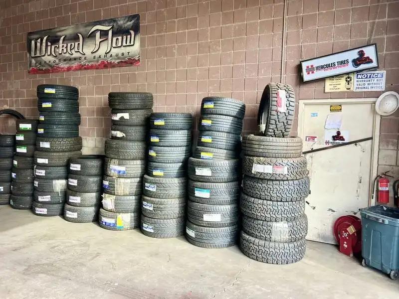 Rows of used SUV tires stacked with size labels